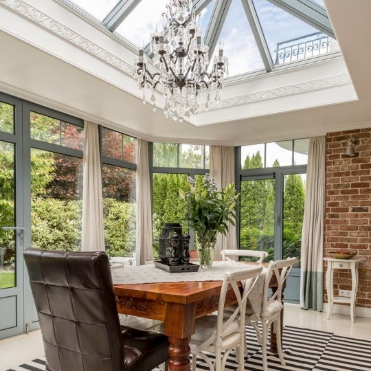 A solid structure, orangery, from the inside of a luxurious dining area